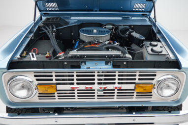 1973 Ford Bronco in Brittany Blue over Whiskey leather engine angle front
