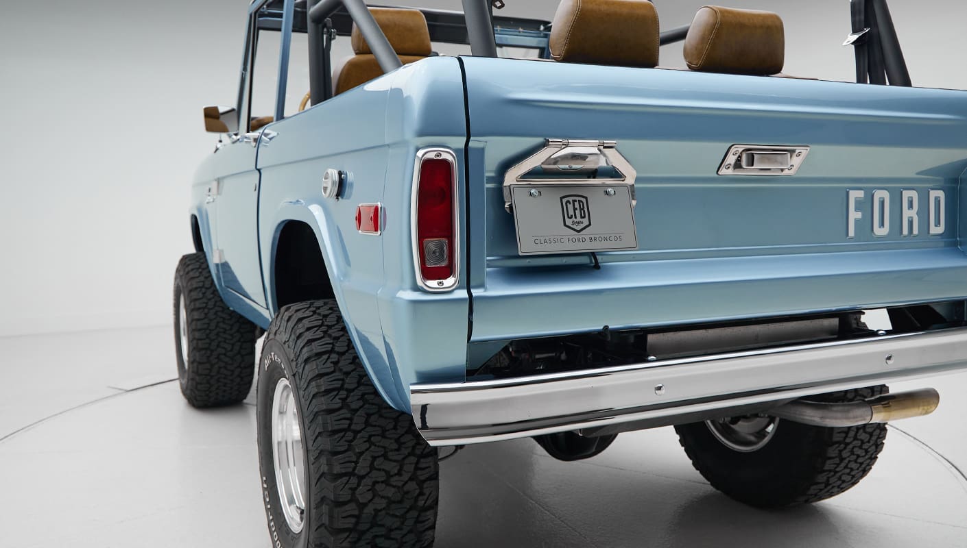 1973 Ford Bronco in Brittany Blue over Whiskey leather rear angle