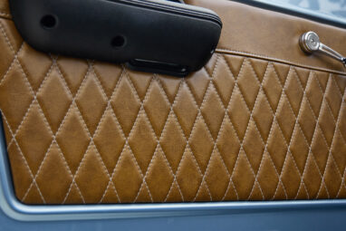 1973 Ford Bronco in Brittany Blue over Whiskey leather door panel detail