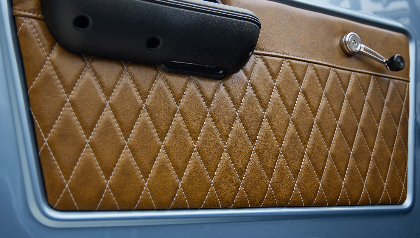 1973 Ford Bronco in Brittany Blue over Whiskey leather door panel detail