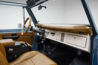 1973 Ford Bronco in Brittany Blue over Whiskey leather passenger dash