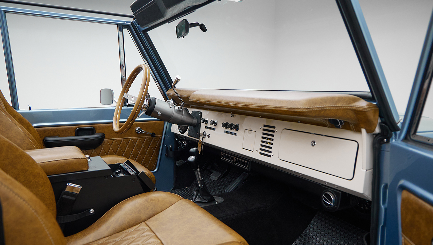 1973 Ford Bronco in Brittany Blue over Whiskey leather passenger dash