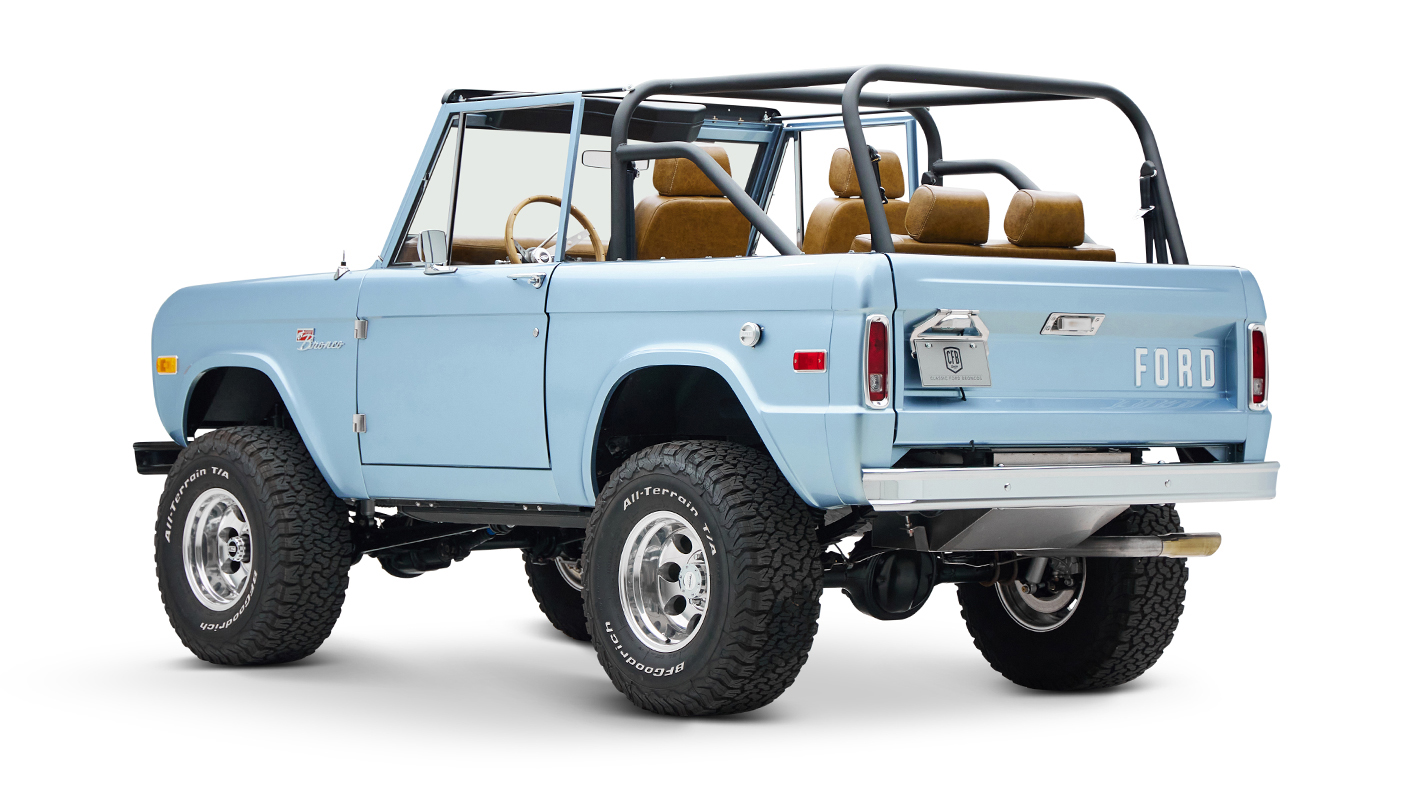 1973 Ford Bronco in Brittany Blue over Whiskey leather driver rear angle