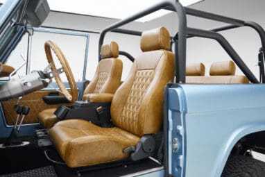 1973 Ford Bronco in Brittany Blue over Whiskey leather driver seat