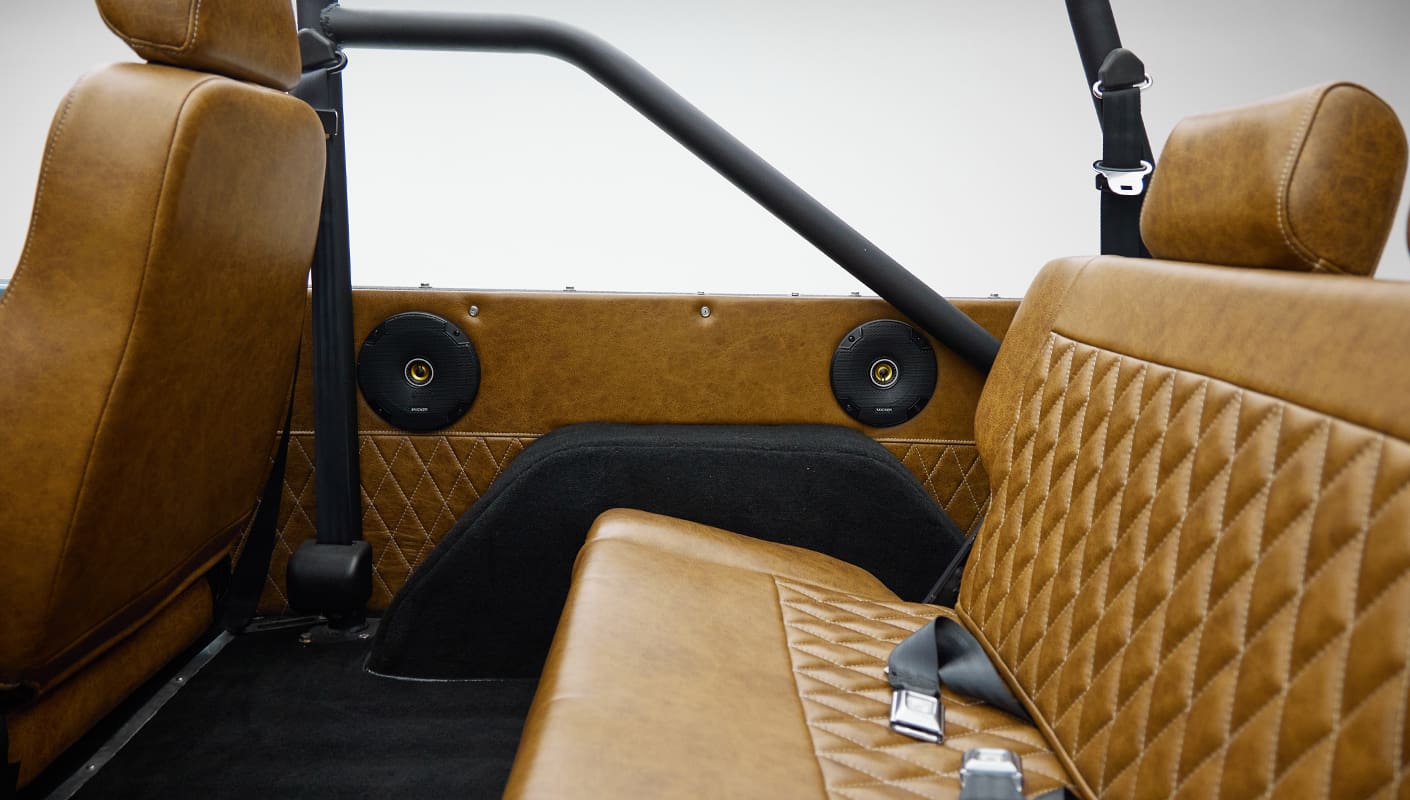 1973 Ford Bronco in Brittany Blue over Whiskey leather rear speaker panel