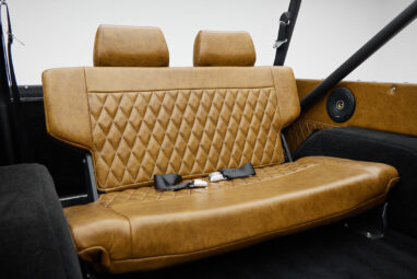 1973 Ford Bronco in Brittany Blue over Whiskey leather rear seat