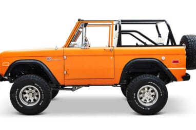 1970 Orange Classic Ford Broncos Coyote Series with white and plaid custom interior and family roll cage