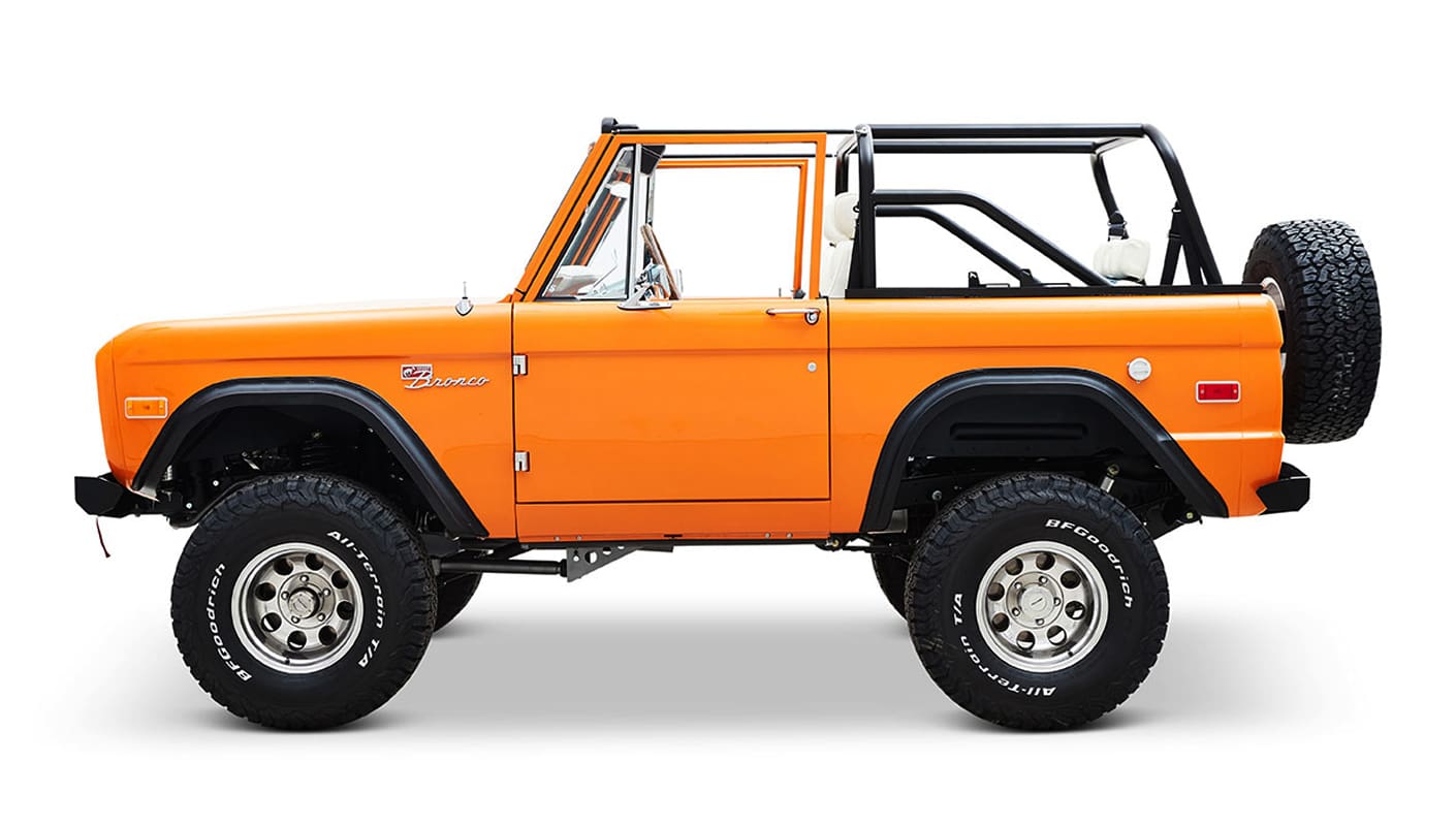 1970 Orange Classic Ford Broncos Coyote Series with white and plaid custom interior and family roll cage