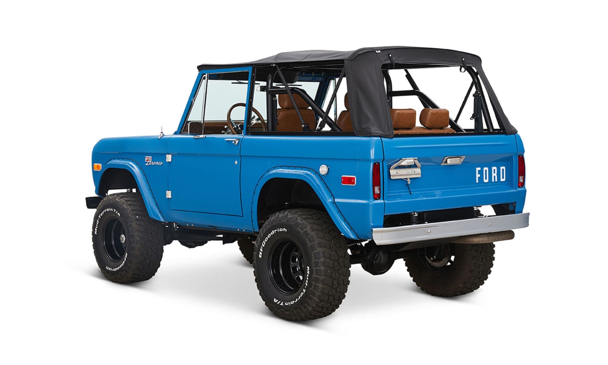 1976 Blue Classic Ford Bronco Coyote Series with black soft top and whiskey leather interior