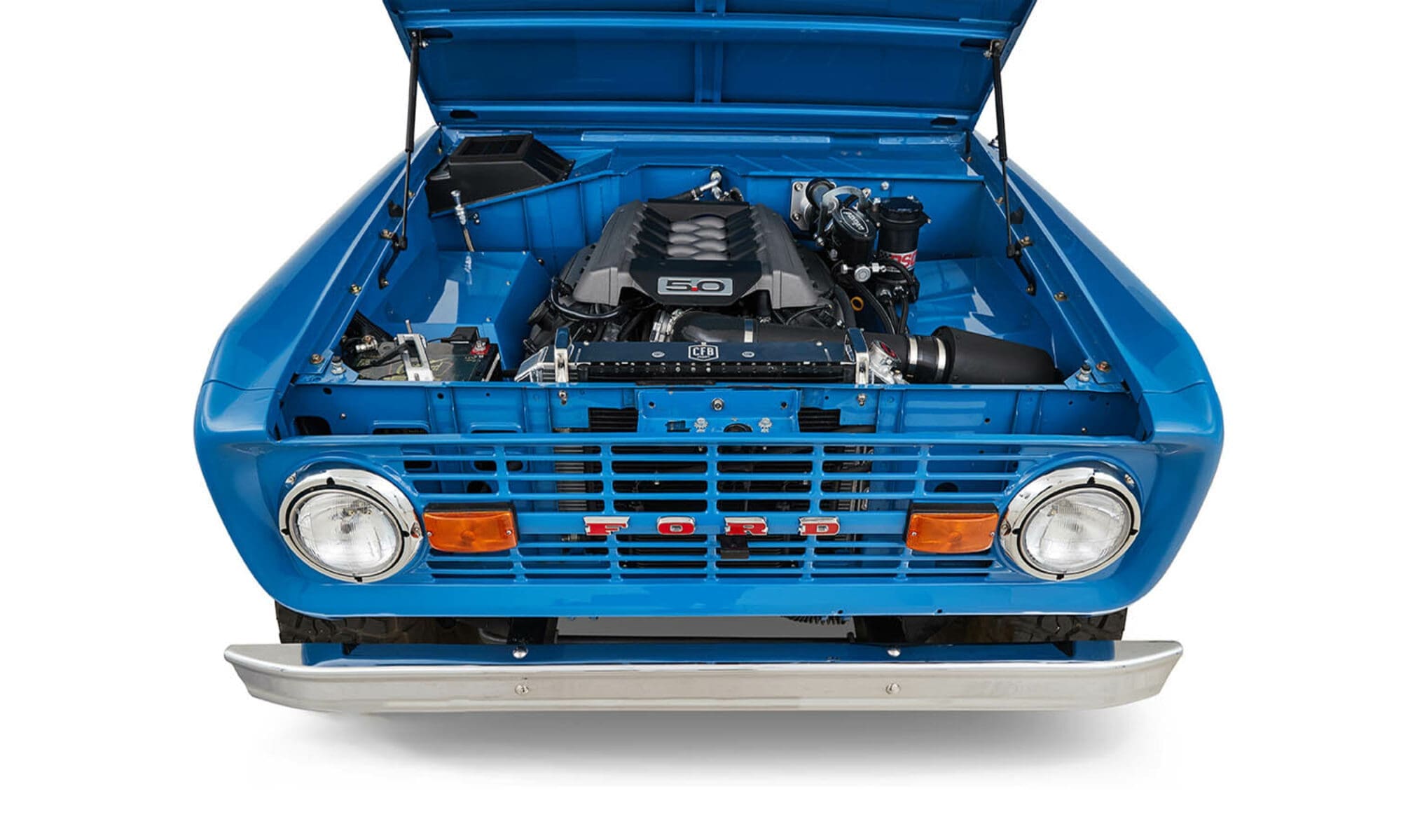 1976 Blue Classic Ford Bronco Coyote Series with black soft top and whiskey leather interior