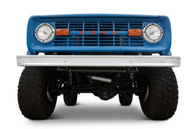 1976 Blue Classic Ford Bronco Coyote Series with black soft top and whiskey leather interior