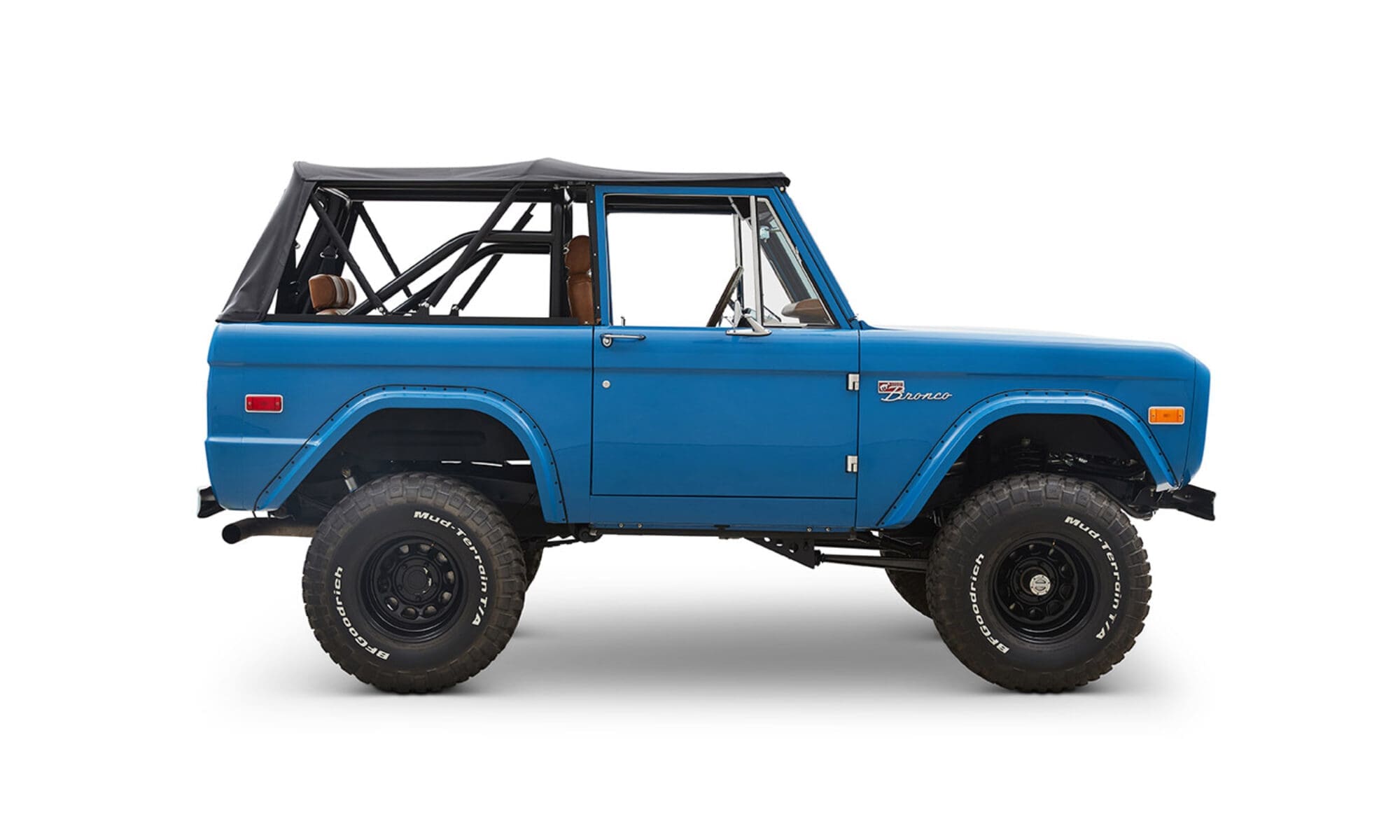 1976 Blue Classic Ford Bronco Coyote Series with black soft top and whiskey leather interior