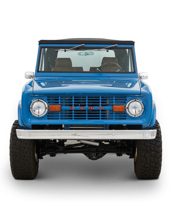 1976 Blue Classic Ford Bronco Coyote Series with black soft top and whiskey leather interior