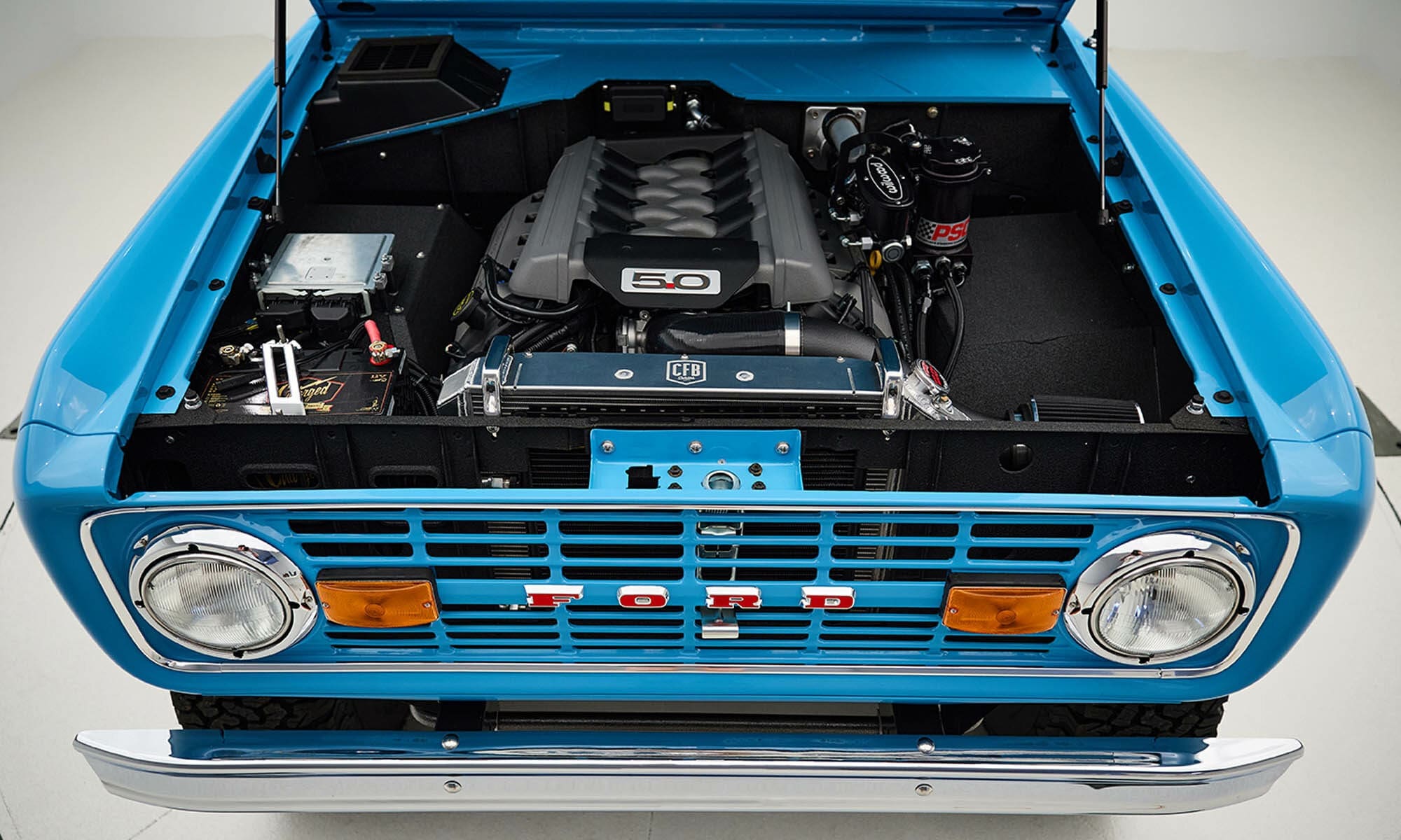 1969 Blue Classic Ford Broncos Coyote Series with Burgundy custom interior, manual transmission and a family roll cage