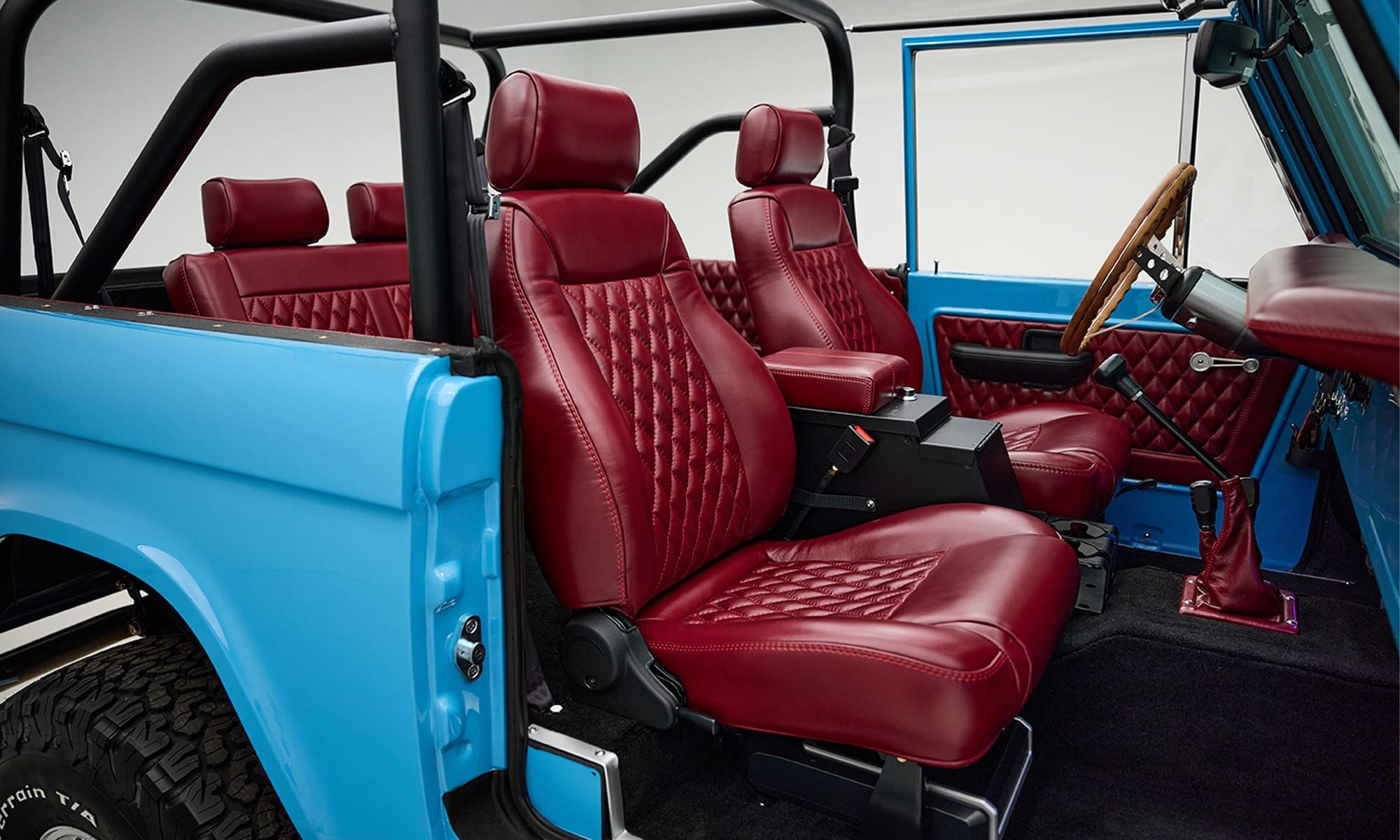 1969 Blue Classic Ford Broncos Coyote Series with Burgundy custom interior, manual transmission and a family roll cage