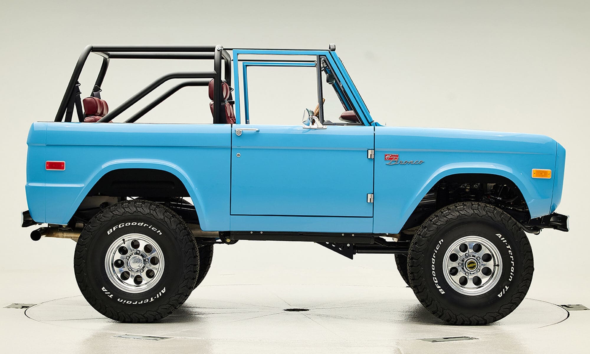 1969 Blue Classic Ford Broncos Coyote Series with Burgundy custom interior, manual transmission and a family roll cage