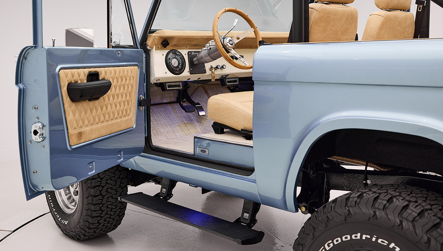 1966 Brittany Blue Classic Ford Bronco with custom diamond stitch interior and factory roll cage