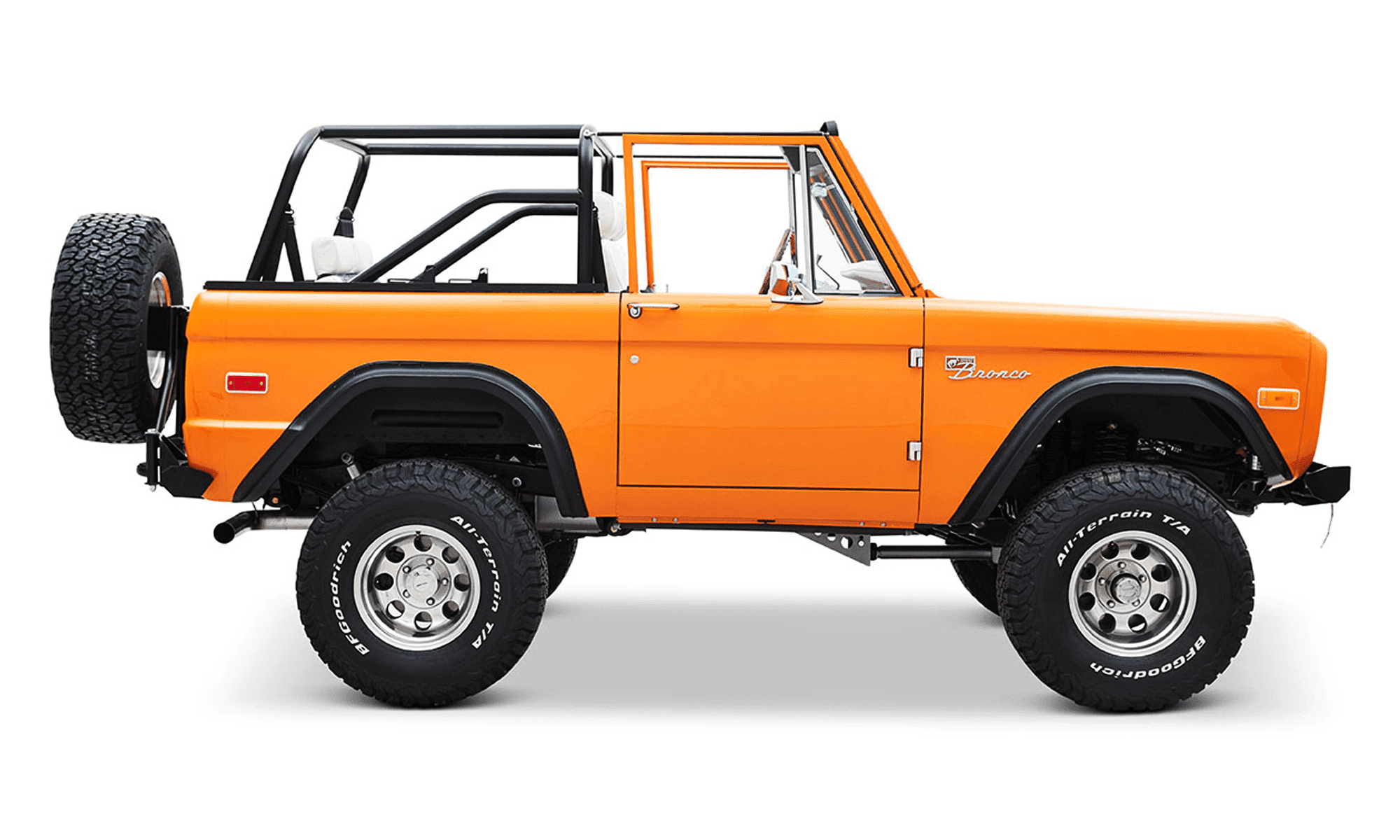1970 Classic Ford Bronco Coyote Series in Orange Crush with custom plaid interior, family roll cage and spare tire carrier.