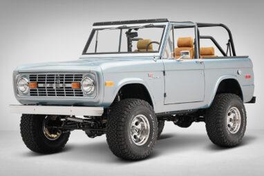 1975 ford bronco painted brittany blue with cowboy debossed, baseball stitch leather front driver angle
