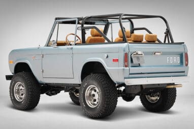 1975 ford bronco painted brittany blue with cowboy debossed, baseball stitch leather rear driver angle