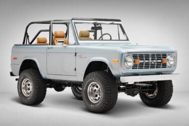 1975 ford bronco painted brittany blue with cowboy debossed, baseball stitch leather front passenger angle