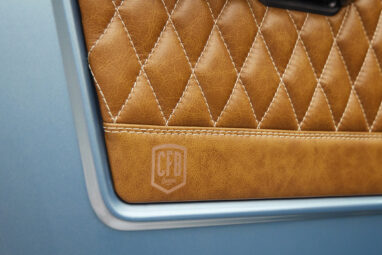 1976 Ford Bronco in Brittany Blue with whiskey diamond stitch door panel