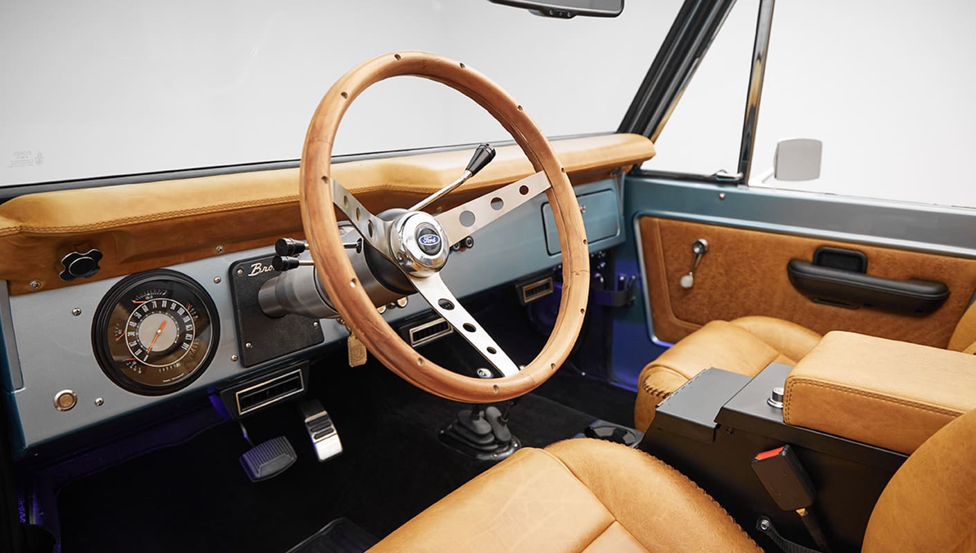 1975 ford bronco painted brittany blue with cowboy debossed, baseball stitch leather steering wheel