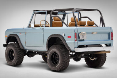 1976 Ford Bronco in Brittany Blue with whiskey diamond stitch driver rear angle