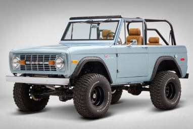 1976 Ford Bronco in Brittany Blue with whiskey diamond stitch driver front angle