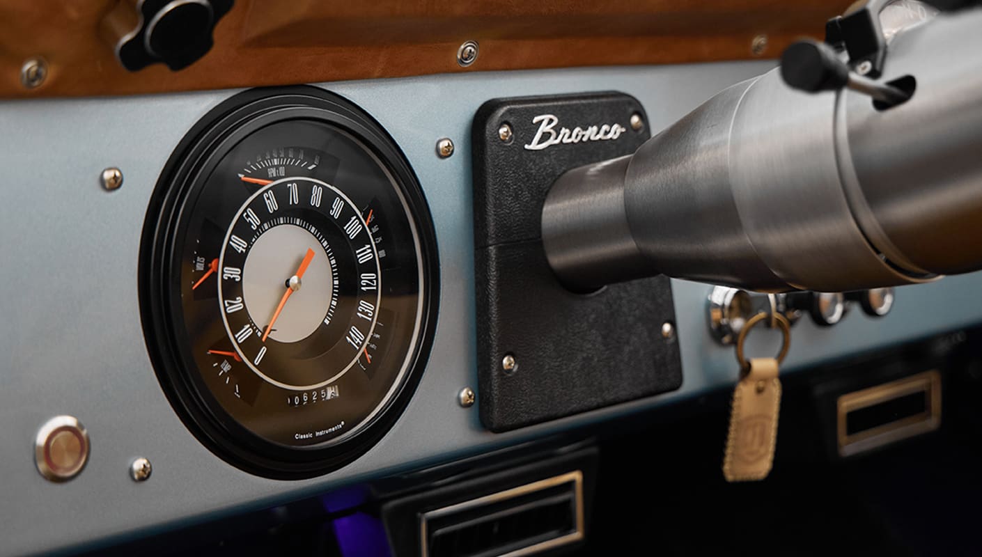 1975 ford bronco painted brittany blue with cowboy debossed, baseball stitch leather gauge