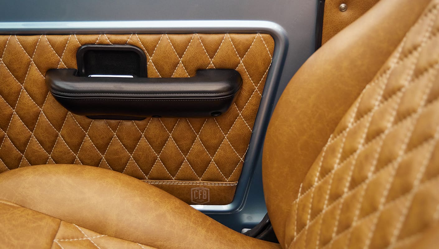 1976 Ford Bronco in Brittany Blue with whiskey diamond stitch leather details