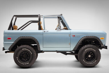 1976 Ford Bronco in Brittany Blue with whiskey diamond stitch passenger side