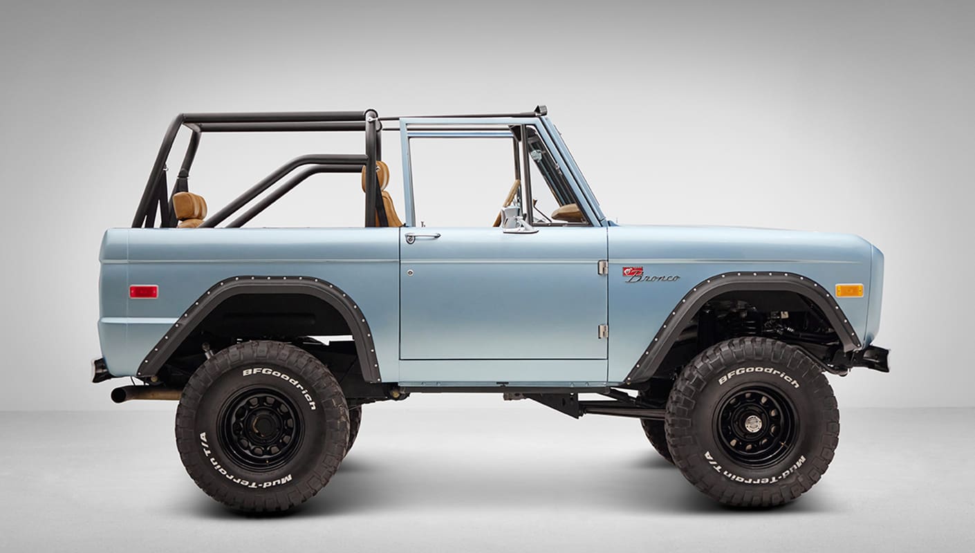 1976 Ford Bronco in Brittany Blue with whiskey diamond stitch passenger side