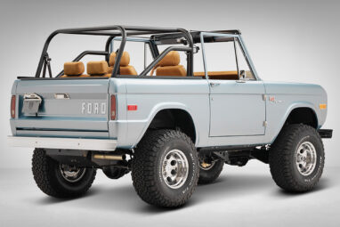1975 ford bronco painted brittany blue with cowboy debossed, baseball stitch leather rear passenger angle