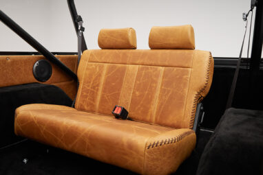 1975 ford bronco painted brittany blue with cowboy debossed, baseball stitch leather rear seat