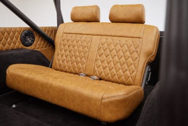 1976 Ford Bronco in Brittany Blue with whiskey diamond stitch leather rear seat