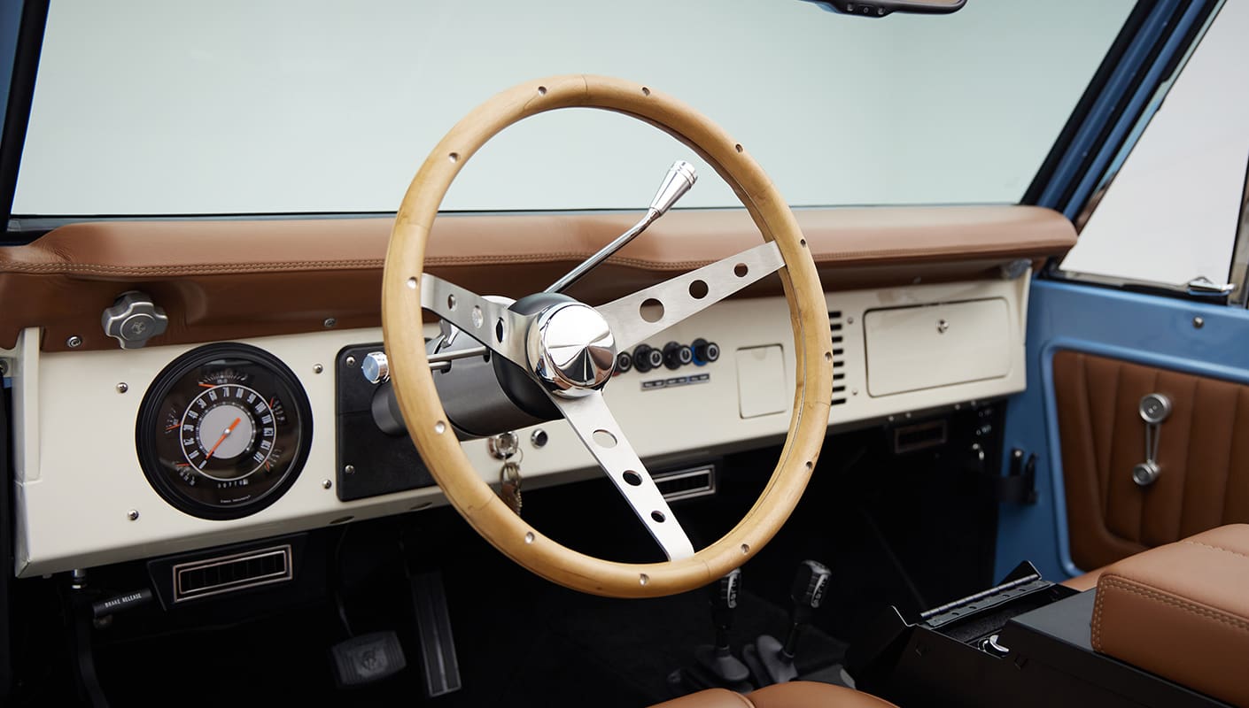 1967 Classic Ford Bronco painted in Frozen Blue over Ball Glove leather interior steering wheel