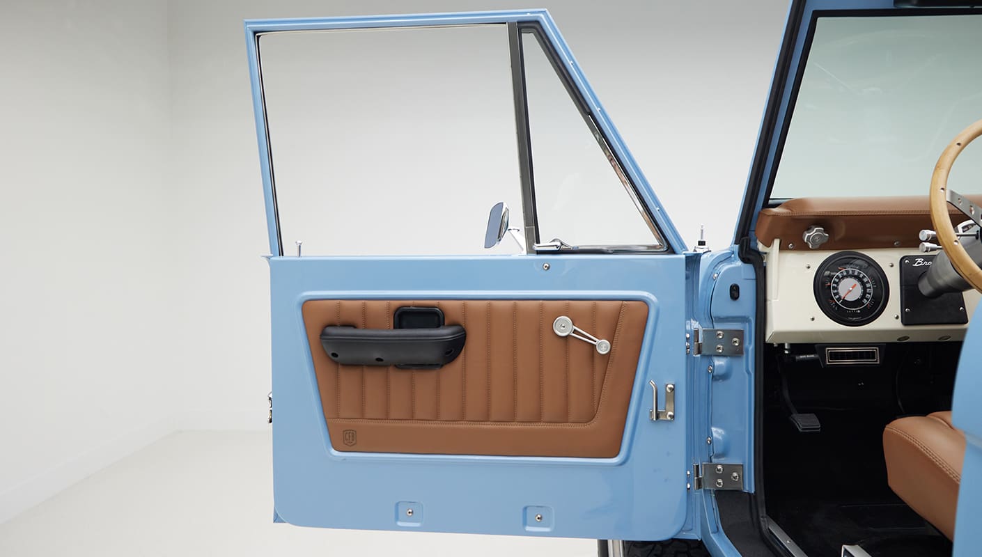 1967 Classic Ford Bronco painted in Frozen Blue over Ball Glove leather interior door panel