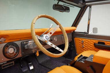 1972 classic ford bronco in matte silver with orange leather interior steering wheel