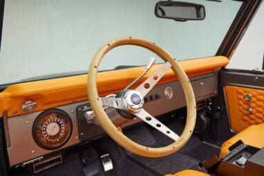 1972 classic ford bronco in matte silver with orange leather interior steering wheel