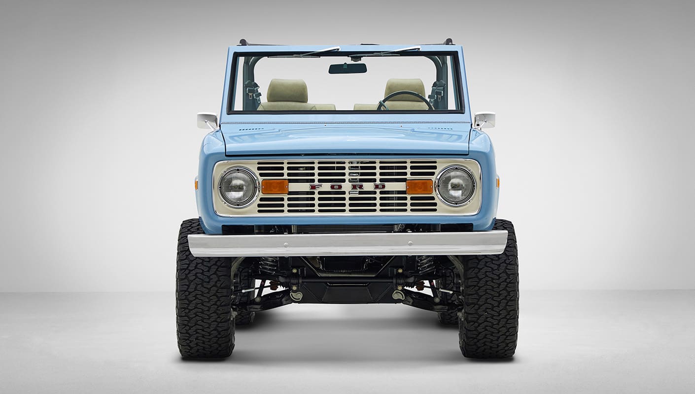 A 1976 Classic Ford Bronco is Frozen Blue over White Rock leather front view