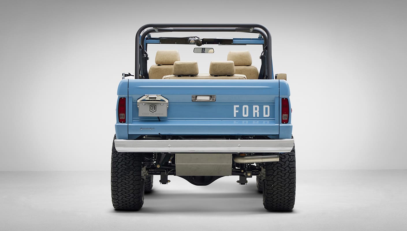 A 1976 Classic Ford Bronco is Frozen Blue over White Rock leather rear