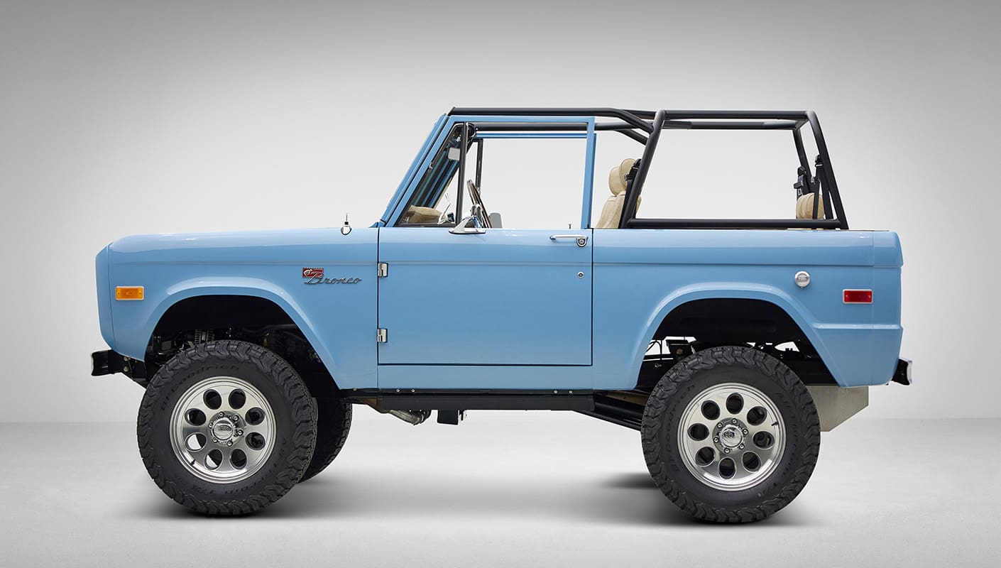 A 1976 Classic Ford Bronco is Frozen Blue over White Rock leather driver profile