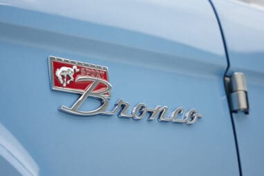 A 1976 Classic Ford Bronco is Frozen Blue over White Rock leather emblem