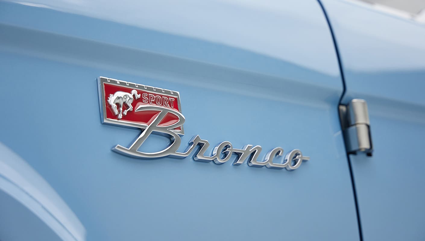 A 1976 Classic Ford Bronco is Frozen Blue over White Rock leather emblem