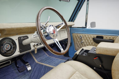 A 1976 Classic Ford Bronco is Frozen Blue over White Rock leather custom steering wheel