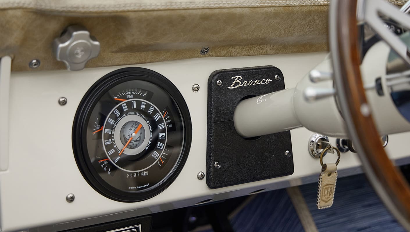 A 1976 Classic Ford Bronco is Frozen Blue over White Rock leather custom grateful dead gauge