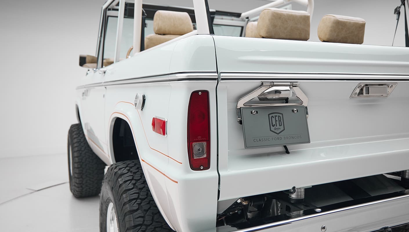 1973 classic ford bronco in diamond blue with butterscotch leather interior, vintage decals and chrome trim rear angle