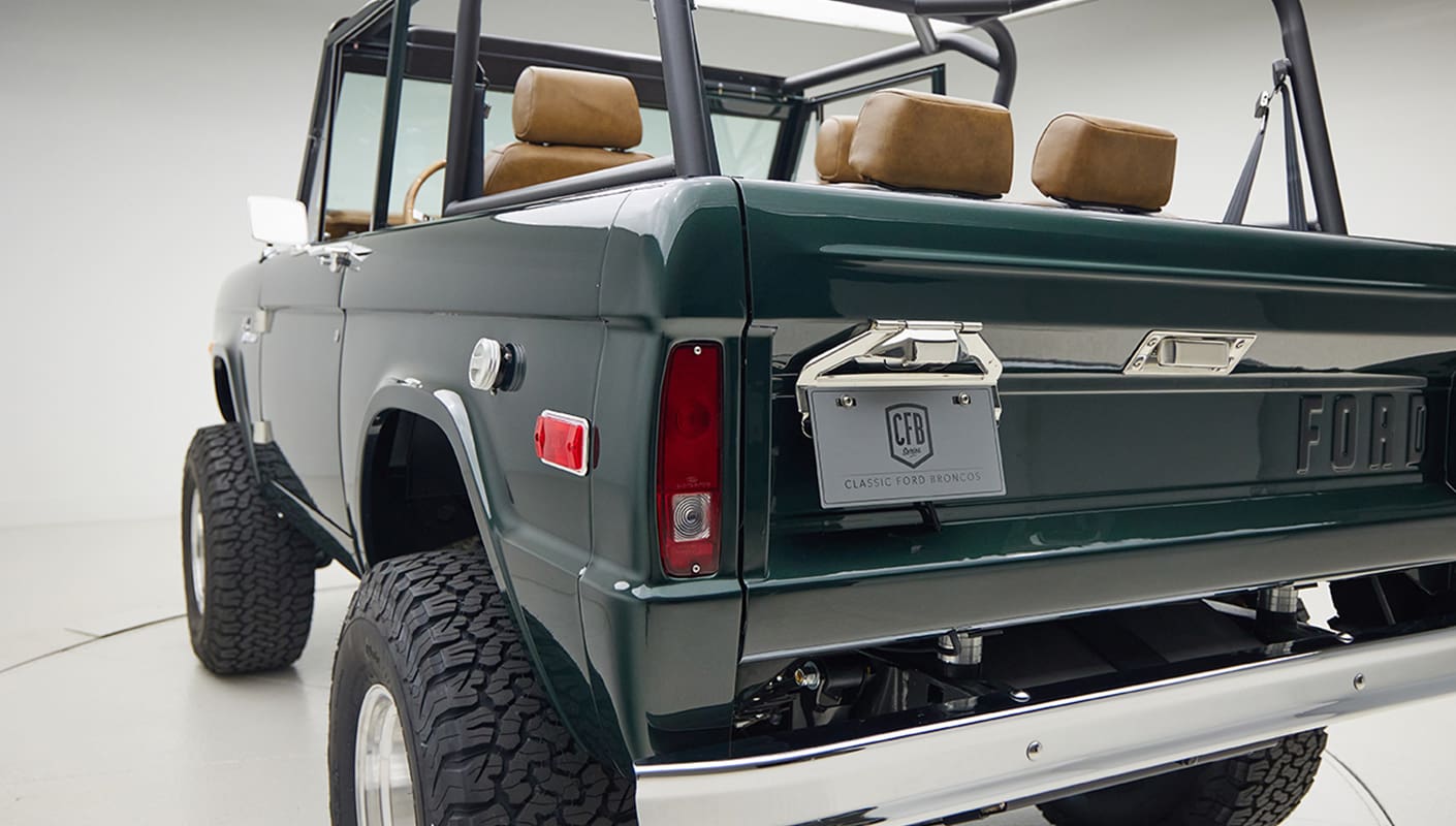 1966 ford bronco in highland green with whiskey leather interior rear angle