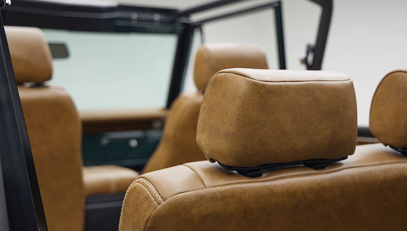1966 ford bronco in highland green with whiskey leather interior headrests